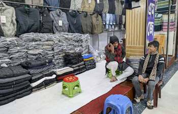 Shopkeepers spend their time idly in a quiet winter market