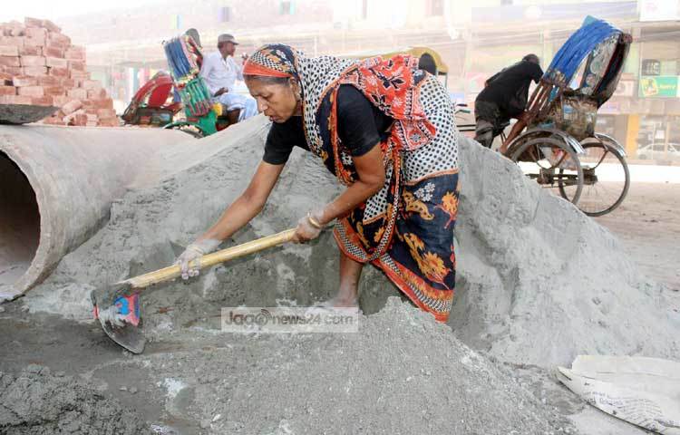 অভাবের সংসারে সচ্ছলতা ফিরিয়ে আনতে এই নারী রাস্তা নির্মাণের কাজ করছেন। ছবি : বিপ্লব দিক্ষিৎ।