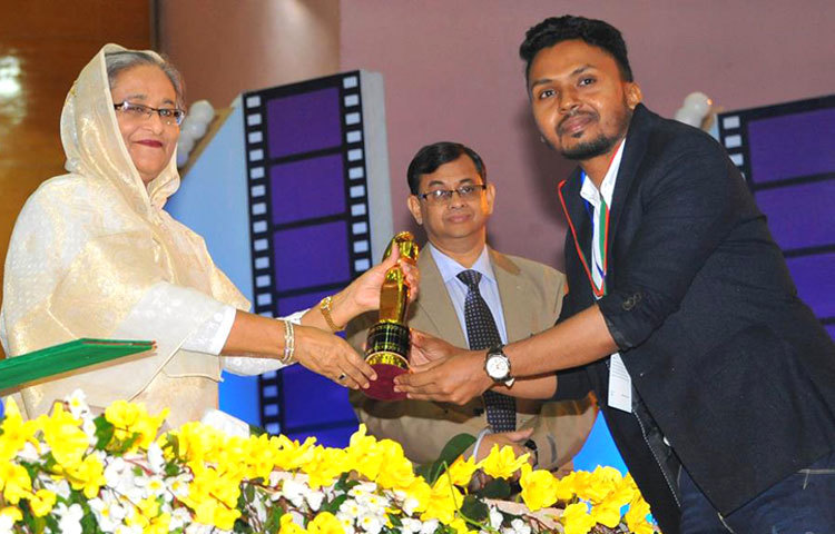 সঙ্গীতশিল্পী ও সঙ্গীত পরিচালক বেলাল খান প্রধানমন্ত্রী শেখ হাসিনার কাছ থেকে পুরস্কার গ্রহণ করছেন।