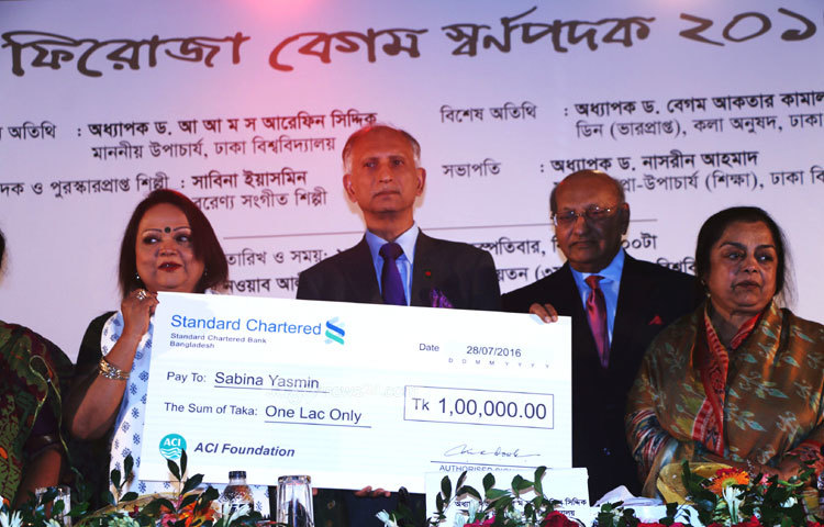 শিল্পী সাবিনা ইয়াসমিনের হাতে &lsquo;ফিরোজা বেগম স্মৃতি স্বর্ণপদক&rsquo;-এর চেক তুলে দিচ্ছেন ঢাকা বিশ্ববিদ্যালয়ের উপাচার্য ড. আ আ ম স আরেফিন সিদ্দিক। ছবি : মাহবুব আলম।