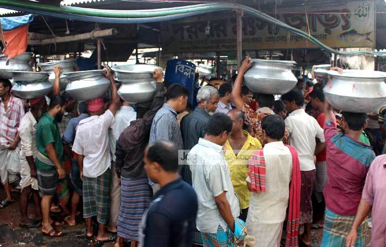 মাছ বিক্রির ধুম পড়েছে। খুচরা বিক্রেতারা মাছ কেনার জন্য ভিড় জমিয়েছেন। ছবি : বিপ্লব দিক্ষিৎ।