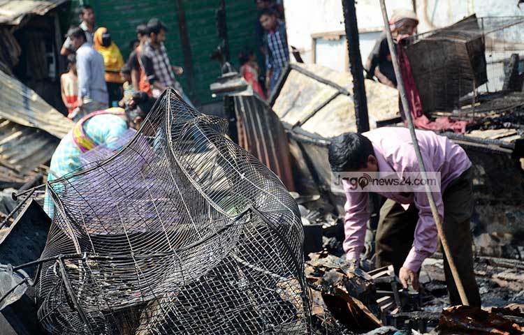 আবারো ঘুরে দাঁড়ানোর চেষ্টায় এই পরিবারটি। তাই আগুনের হাত থেকে রক্ষা পাওয়া বাকি মালামাল সংগ্রহ করছেন। ছবি : বিপ্লব দিক্ষিৎ