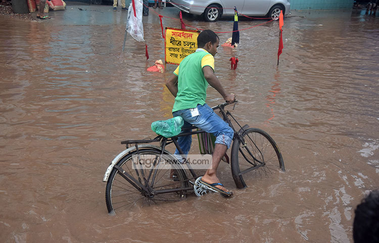 মুষলধারে বৃষ্টিতে নগরীর পাড়া-মহল্লার অলিগলি ও রাজপথের বিভিন্ন স্থান বৃষ্টির পানিতে ডুবে জলাবদ্ধতা দেখা দেয়ার ফলে হাজার হাজার মানুষ চরম দুর্ভোগে পড়েছেন। ছবি : মাহবুব আলম