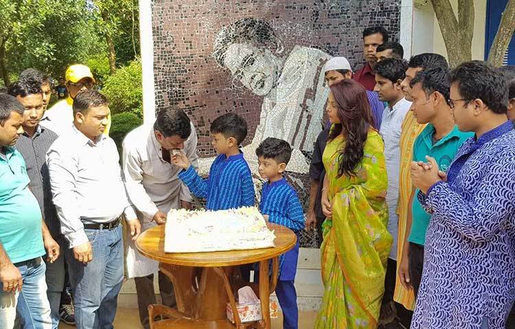 হুমায়ূন পুত্র এক জনকে তার বাবার জন্মদিনের কেক খাইয়ে দিচ্ছেন।