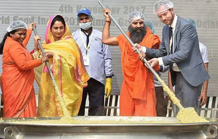 ৯১৮ কেজি খিচুড়ি রান্নার সময় সহযোগিতা করেন ভারতের যোগগুরু রামদেব।