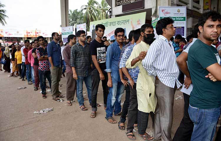 টিকিট সংগ্রকারীদের দীর্ঘ লাইন কাউন্টার ছাপিয়ে বাইরে গিয়েছে। টিকিট পাওয়ার জন্য সবাই অধীর আগ্রহে আছেন। ছবি : বিপ্লব দিক্ষিৎ