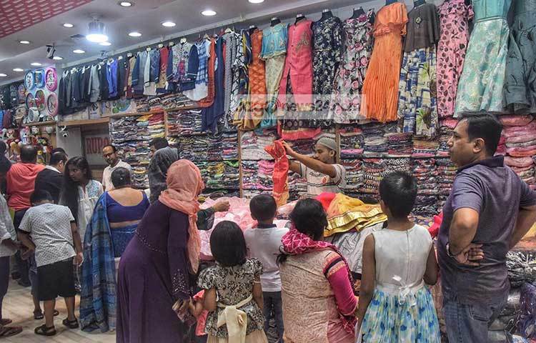 দোকানটিতে ঈদের কেনাকাটার ব্যস্ততা। শিশুদের জন্য ঈদের পোশাক কিনছেন অভিভাবকরা। ছবি : মাহবুব আলম