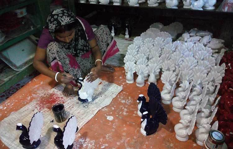 মাটির তৈরি বিভিন্ন প্রাণীর গায়ের রং লাগাচ্ছেন একজন মৃৎশিল্পী। মৃৎশিল্পের পল্লি ফরিদগঞ্জের পাইকপাড়া গ্রামের কুমার বাড়ি থেকে এ ছবি তোলা হয়েছে।