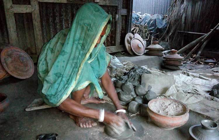 মাটি দিয়ে জিনিসপত্র বানাচ্ছেন এক শিল্পী।