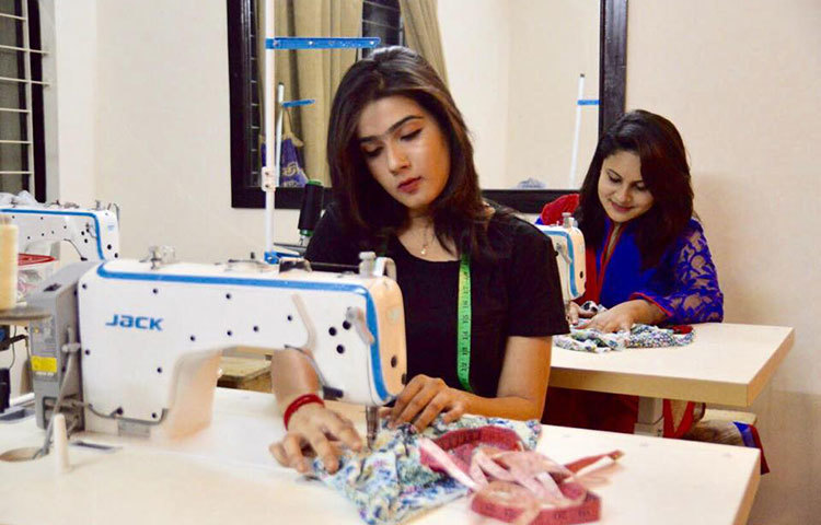 জামা সেলাই করছেন মাহি।