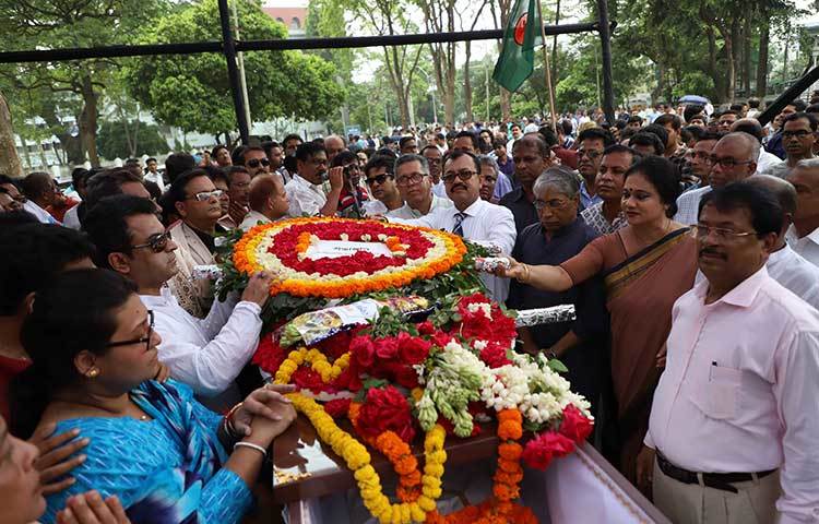 ফুলের ঢালা নিয়ে শ্রদ্ধা জানাতে এসেছেন শিল্পীর ভক্তরা। ছবি: বিপ্লব দিক্ষিৎ