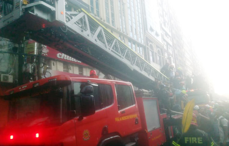 ফায়ার সার্ভিসের মই ব্যবহার করে ভবনের ১২তলা থেকে আটকা পড়াদের উদ্ধার করছেন সেনাবাহিনীর সদস্যরা।