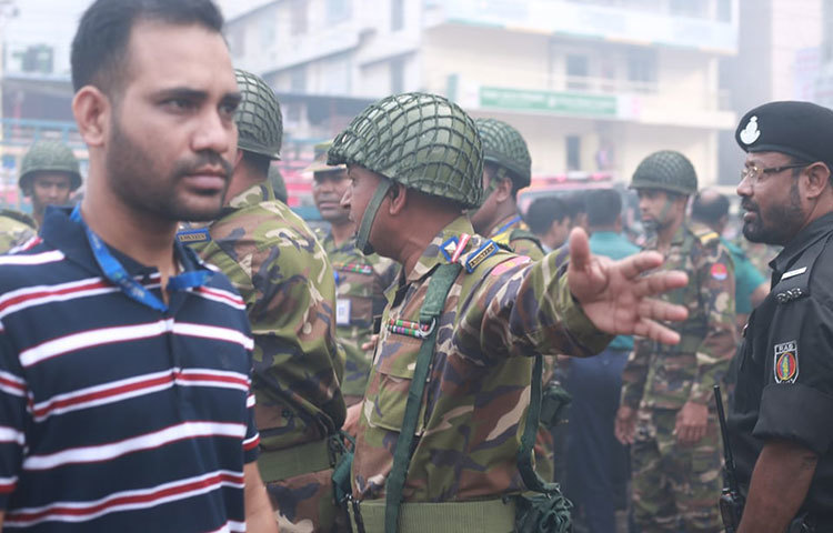 আগুন লাগা দেখতে আসা কৌতূহলী মানুষ নিয়ন্ত্রণে আনার জন্য ছুটে সেনাবাহিনীর সদস্যরা। ছবি: মাহবুব আলম