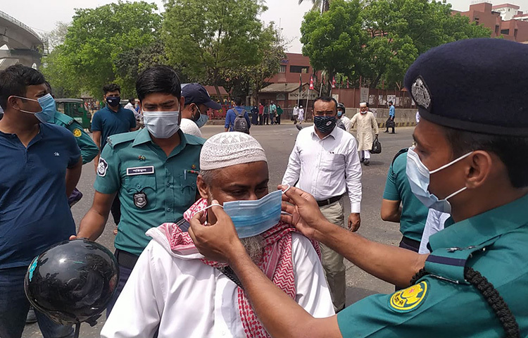 আজ রাজধানীর শান্তিনগর ট্রাফিক বক্স সংলগ্ন পথচারী ও সাধারণের মাঝে মাস্ক বিতরণ করে ঢাকা মেট্রোপলিটনের পুলিশের সদস্যরা। ছবি: জাগো নিউজ