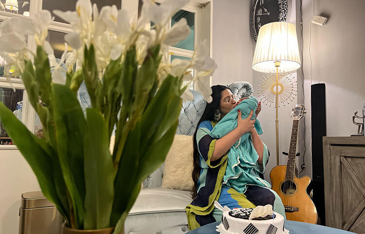 মাত্র একমাস আগেই তাদের ঘর আলো করে এসেছে পুত্র শাহীম মুহাম্মদ রাজ্য। রাজ্যকে আদর করছেন পরীমিন। ছবি: ফেসবুক