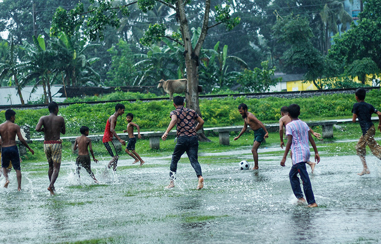 চলছে বৃষ্টি মাখা ফুটবল ম্যাচ। ছবি: সাজেদুর আবেদীন শান্ত