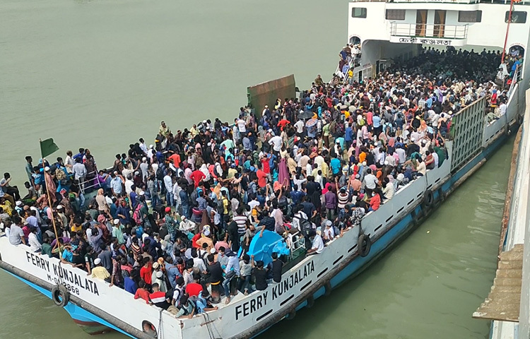 সকাল থেকে ঘাট এলাকায় কোনো যানবাহন ঢুকতে দিচ্ছে না পুলিশ। ফলে কয়েক কিলোমিটার হেঁটেই ঘাটে যাচ্ছেন যাত্রীরা। ফেরি বন্ধ থাকার খবর শুনে নিরুপায় হয়ে ঘাটে অপেক্ষা করছেন কেউ কেউ। অনেকে আবার ফিরছেন রাজধানীর পথে। ছবি: আরাফাত রায়হান সাকিব