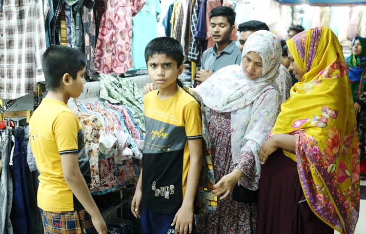 মা-বাবার সঙ্গে এসে পছন্দের পোশাকটি ট্রায়াল দিয়ে কিনে নিচ্ছেন শিশু-কিশোররা। ছবি: মাহবুব আলম
