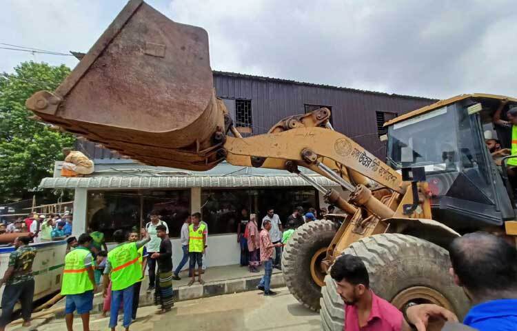 এর আগে দুপুর পৌনে ১২টার দিকে একটি পেলোডার, একটি হুইল এক্সক্যাভেটর, তিনটি বেক-হো লোডার নিয়ে হাজির হন সিটি করপোরেশনের ভ্রাম্যমাণ আদালত। ছবি: মাহবুব আলম