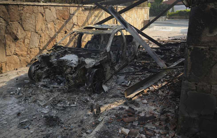 ভয়াবহ দাবানলের সময় সাইপ্রাসের সৌনি গ্রামে একটি পুড়ে যাওয়া গাড়ি দেখা যাচ্ছে।