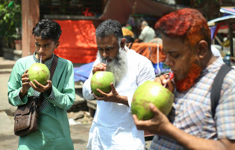 কেউবা ডাব খেয়ে তৃষ্ণা মেটানোর চেষ্টা করছেন। ছবি: মাহবুব আলম