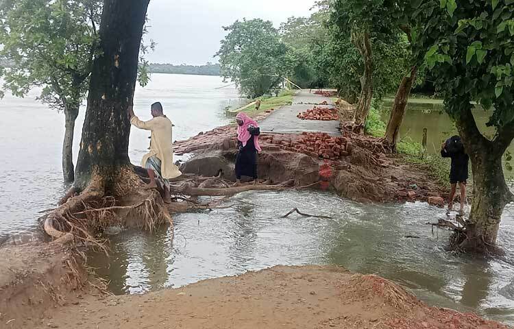 ভাঙা সড়কের ওপর দিয়ে জীবনের ঝুঁকি নিয়ে চলাচল করতে হচ্ছে নারী-পুরুষ ও শিশুদের। ছবি: লিপসন আহমেদ