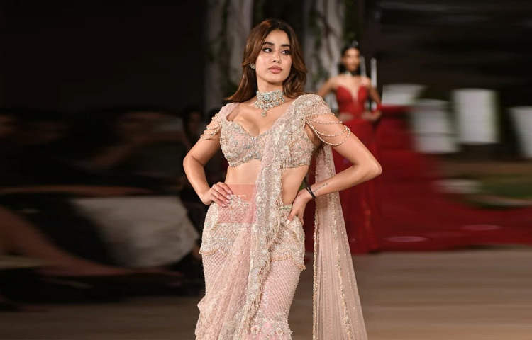 Janhvi chose a pastel peach lehenga with intricate embroidery as the showstopper. It was accompanied by a long veil of sheer fabric, which flowed down the back like a train; the edges of the veil were adorned with delicate fringe and stone work, which added charm to every movement of the dress.