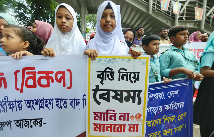 মানববন্ধনে অংশ নিয়েছে অনেক ছোট ছোট শিক্ষার্থীও। হাতে পোস্টার, ‘বৃত্তি নিয়ে বৈষম্য, মানি না মানব না’।