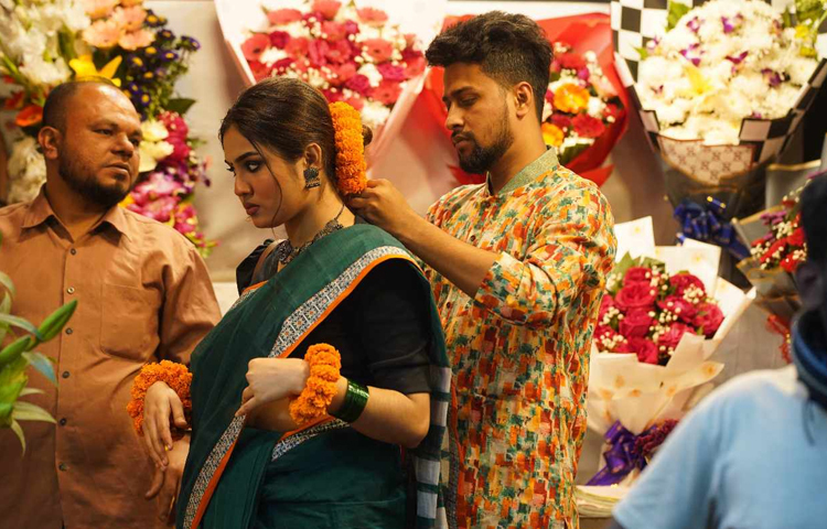 ফুল কিনে পরিয়ে দিচ্ছে প্রিয় মানুষের খোপায়। ছবি: মাহবুব আলম