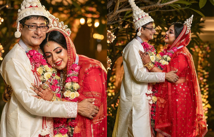 লাল বেনারসি, গা ভর্তি সোনার গয়না, শোলার মুকুট আর ফুলের সাজে শ্রীময়ী সেজেছেন মনের মতো করে। বরের সাজও কম জমকালো নয়। ধুতি আর ভারী কাজ করা পাঞ্জাবিতে কাঞ্চনও পাল্লা দিয়েছেন। বিয়ের বেনারসি নিজেই নকশা করেছেন শ্রীময়ী। ছবি: সংগৃহীত
