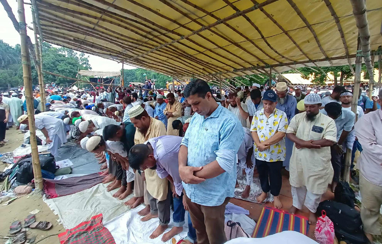কেউ মঞ্চের সামনেই দাঁড়িয়ে যান, কেউ আবার নিজেদের পাঞ্জাবি, গামছা বা পত্রিকা বিছিয়ে নিচে বসে পড়েন।