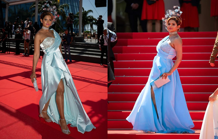 আকাশি-নীলের কোমল আভায় কানে চতুর্থ দিনের লুকে নজর কাড়লেন প্রিয়তি। তার পরনে ছিল ওয়ান শোল্ডার, সাইড স্লিট ডিজাইনের একটি ঝলমলে গাউন, যার সঙ্গে চমৎকারভাবে মানিয়ে গেছে মাথায় পরা একটি দৃষ্টিনন্দন হেডপিস। ফুল ও তারার কারুকাজে তৈরি এই হেডপিসটির নকশা করেছেন আইরিশ ডিজাইনার ফিওনা রাফটার যার সৌন্দর্যের ছায়া গাউনের রঙ ও ছাঁটেও স্পষ্ট। পায়ে ছিল ঝলমলে সিলভার হিল, আর হাতে অনুষঙ্গ হিসেবে থাকল ক্লাচ যা পুরো লুকে যোগ করেছে পরিপূর্ণতা।