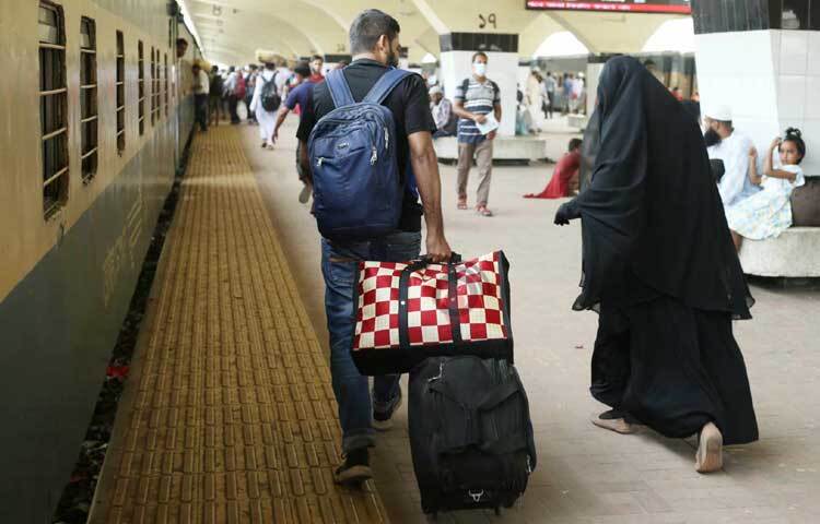 ট্রেনে উঠার জন্য দ্রুত হেঁটে চলছেন যাত্রীরা।  ছবি: মাহবুব আলম