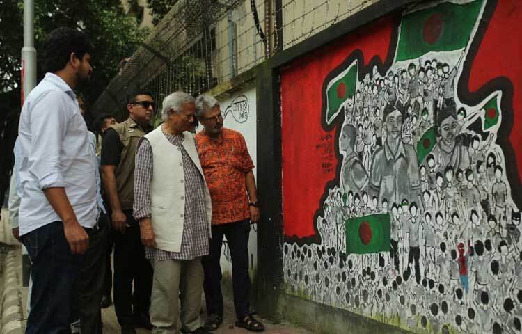 তিনি ঘুরে ঘুরে দেখছেন দেয়ালের সব গ্রাফিতি।