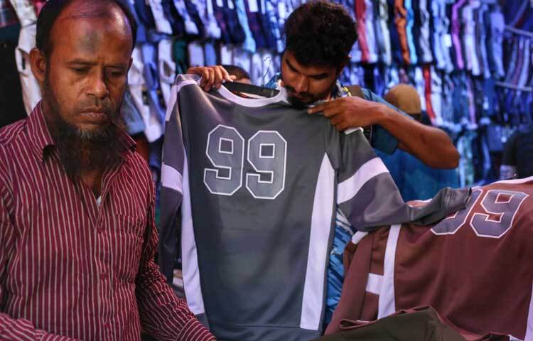 পোশাক বাছাইয়ে ক্রেতাদের সহযোগিতা করছেন দোকানিরা।