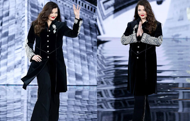 শেরওয়ানির প্রতিটি কোণায় ঝলমল করছে হীরাখচিত কারুকাজ। উঁচু কলার, স্প্লিট নেকলাইন আর সামনে সাজানো হীরার বোতাম পোশাকটিকে মহিমাময় করেছে। সবচেয়ে চোখে পড়ার মতো ছিল হাতের ১০ ইঞ্চি জুড়ে বিস্তৃত সূক্ষ্ম হীরার এমব্রয়ডারি। সঙ্গে মানানসই ফ্লেয়ারড ট্রাউজার ও হাই হিলে ঐশ্বরিয়া হয়ে উঠেছেন অনন্য। এই পোশাকে মণীশ মলহোত্রা যেন প্রমাণ করেছেন ঐতিহ্য ও আধুনিকতার মিলন হতে পারে নিখুঁত।