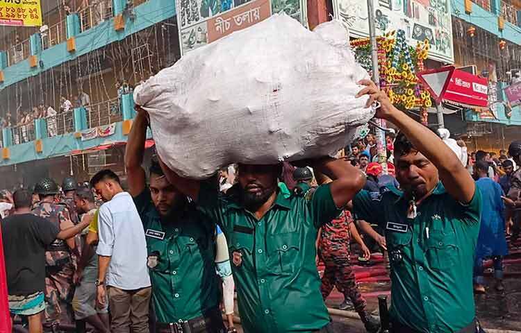 অগ্নিকাণ্ডের সময় বিভিন্ন দোকানের মালামাল নিরাপদ স্থানে নিয়ে যাচ্ছে দোকানীরা। ছবি: জাগো নিউজ