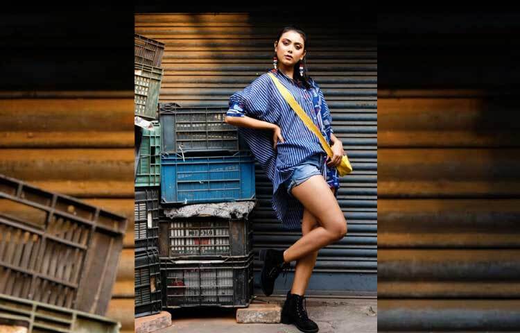 নেভিব্লু ওভারসাইজ কটন শার্ট, ডেনিম শর্টস, হলুদ রঙের ব্যাগ আর অ্যাঙ্কেল লেন্থ বুটে দারুণ লাগছে তাকে। ছবি: ফেসবুক থেকে