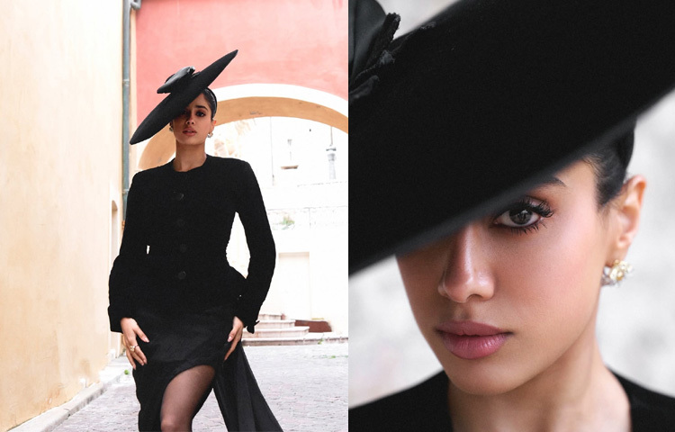 এই টপের সঙ্গে ভারসাম্য রাখতে জাহ্নবী পরেছেন ভারতীয় ডিজাইনার অনামিকা খান্নার তৈরি কালো সিল্ক শিফন স্কার্ট, যাতে রয়েছে নাটকীয় কাপড়ের এক্সটেনশন-যা পুরো লুকটিকে দিয়েছে এক অনন্য আভিজাত্য। অলংকারে ছিল মাত্র একটি টাচ সুইস ব্র্যান্ড ‘চোপার্ড’-এর মিনিমাল হীরার দুল, যা যোগ করেছে পরিশীলিততা।