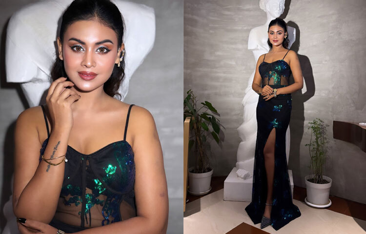 স্বচ্ছ ফেব্রিকের কালো কোরসেট গাউনে মেঘলার উপস্থিতি যেন মোহিত করে তোলে দৃষ্টিকে। ফ্লোর লেংথ এই পোশাকে সাইড স্লিট ডিজাইনটি তার লুককে দিয়েছে বাড়তি সাহসী মাত্রা। আলো-ছায়ার খেলায় উজ্জ্বল হয়ে উঠেছে তার আত্মবিশ্বাস।
