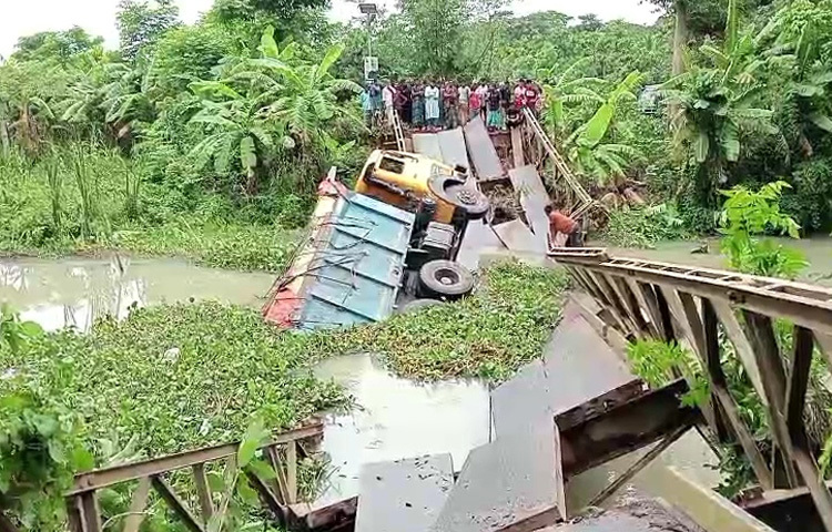 পিরোজপুরের ইন্দুরকানিতে কয়লা বোঝাই একটি ট্রাক নিয়ে ভেঙে খালে পড়ে গেছে বেইলি ব্রিজ। এতে করে কলারন-সন্ন্যাসী-মোড়লগঞ্জ-পিরোজপুর সড়কে যোগাযোগ বিচ্ছিন্ন হয়ে পড়েছে। ছবি: মো. তরিকুল ইসলাম