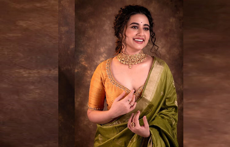 ছোট্ট লাল টিপ, হালকা ব্রিক রেড লিপস্টিক, কোঁকড়া চুলের নরম স্ট্র্যান্ডস আর ভারী চোকার-সব মিলিয়ে একেবারে নিখুঁত।