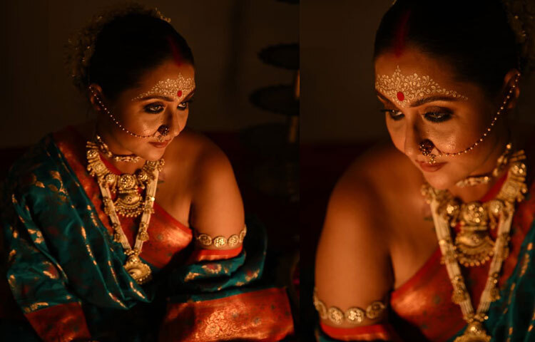 Gold and orange bows on teal green, and wide embroidered lace - this Benarasi swastika look has come alive in the play of light and darkness.