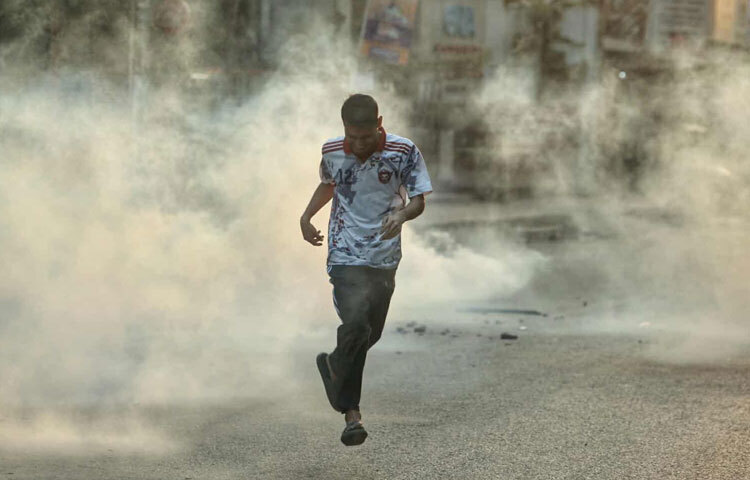 দিনের বেলা তুলনামূলক শান্ত থাকলেও বিকেল ৪টা ৫০ মিনিটে তোলা ছবিটিতে ধরা পড়েছে হঠাৎ উত্তেজনা ছড়িয়ে পড়ার দৃশ্য। নিত্যদিনের ব্যস্ত এলাকা আজ অন্যরকম; স্কুল–কলেজমুখী পথ, লেকপাড়ের হাঁটার রাস্তা, দোকানপাট সবই আজ গুমোট।