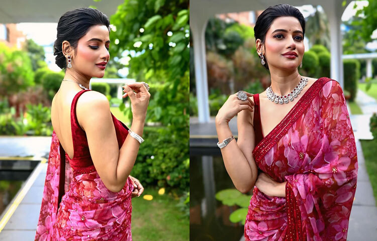 ঊষসী রায়ের ফ্লোরাল শাড়ি, ব্যাকলেস ব্লাউজ আর মানানসই পাথরের গয়নায় ফুটে উঠেছে পূজার কোমলতা। তার সফট গ্ল্যাম মেকআপ যেন বাড়তি এক মায়া।