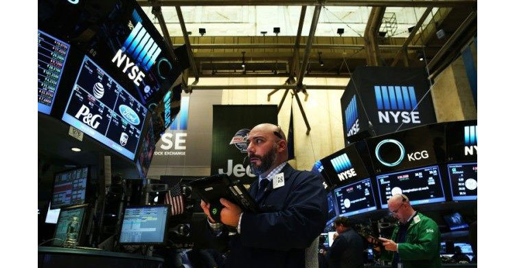 US stocks rise, dollar falls on cautious Fed outlook