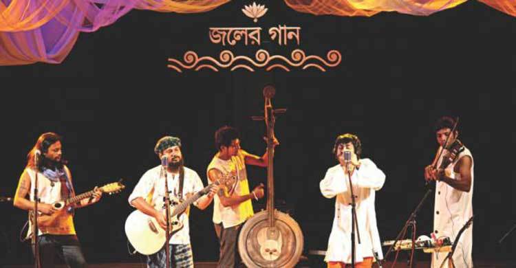 Joler Gaan stands beside flood victims