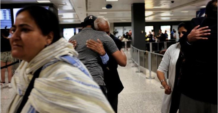 US judge narrows travel ban in defeat for Trump