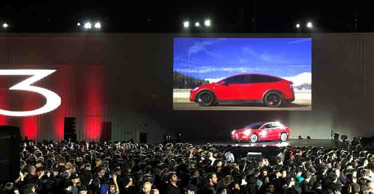 Elon Musk hands over first Tesla Model 3 electric cars to buyers