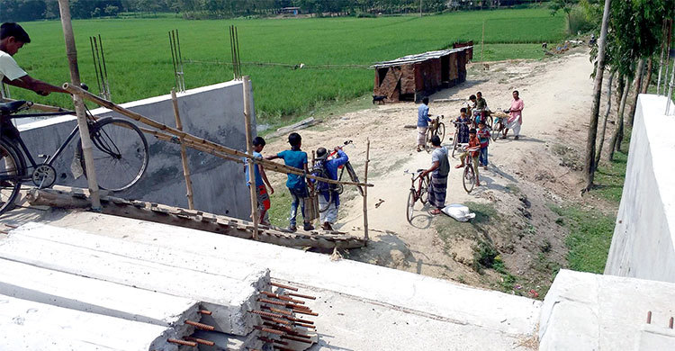 কাঁধে সাইকেল নিয়ে সেতু পার